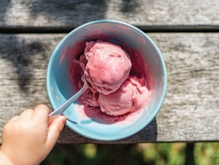 A colourful bowl of strawberry ice cream